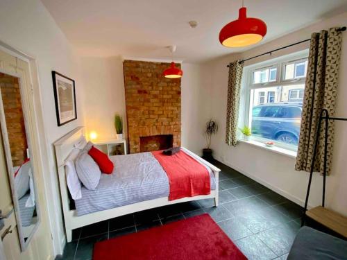 a bedroom with a bed and a window at Brickworks - 2 bedrooms, 15 mins walk to the centre, with garden in Cardiff