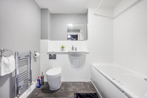 a white bathroom with a toilet and a sink at Beautiful Large rooms in Ashford in Willesborough