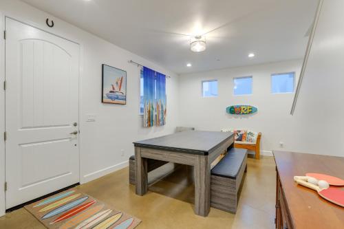a dining room with a wooden table and a desk at Stunning Getaway Less Than 1 Mi to Grover Beach! in Grover Beach