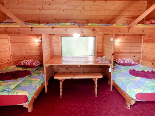 a room with two beds in a log cabin at Sõrve Holiday Home in Kargi