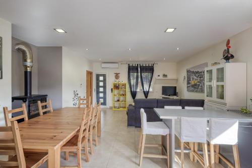 a kitchen and living room with a table and chairs at Casa Azevedo in Vila Nova de Famalicão