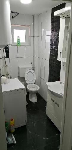 a bathroom with a white toilet and a sink at YOUR home in Belgrade