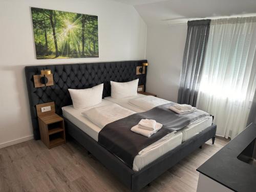 a bedroom with a bed with two towels on it at Ferienwohnung am Freudenthal in Soltau