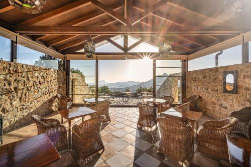 a restaurant with tables and chairs on a patio at Hotel Alahuar in Benimaurell