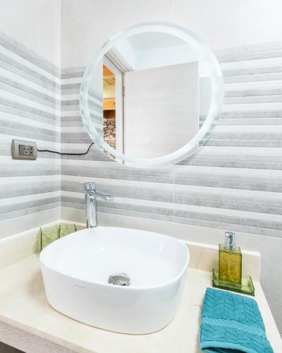 a bathroom with a white sink and a mirror at Estrella Village Loft 301A Close to the Dominicus Beach in La Laguna