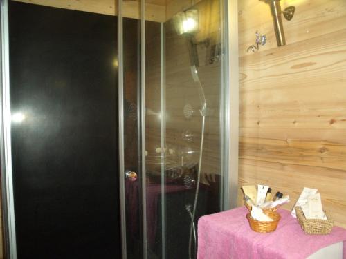 a bathroom with a shower with a table with a pink cloth at Chez Jean Marc et Corinne in Priay