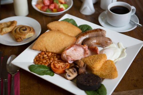 a plate of food on a table with coffee and food at Best Western Gables Hotel in Falfield