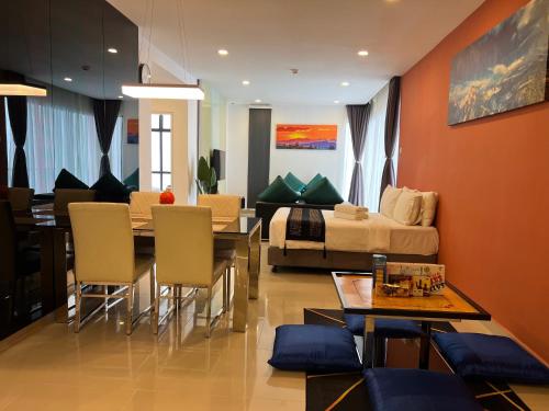 a living room with a bed and a table and chairs at QUINCE HOME GRAND ION DELEMEN GENTING HIGHLANDs in Genting Highlands