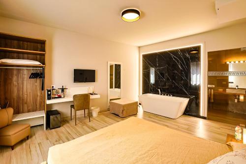 a bedroom with a bathroom with a tub and a sink at Le Suite in Polistena