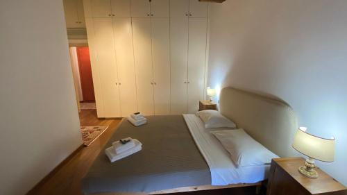 a bedroom with a large bed with a nightstand and a lamp at Piazza Erbe Lodge in Verona