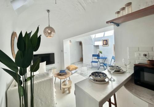 a kitchen and living room with a table and chairs at Zina Apartment à Sidi Bou Saïd in Sidi Bou Saïd