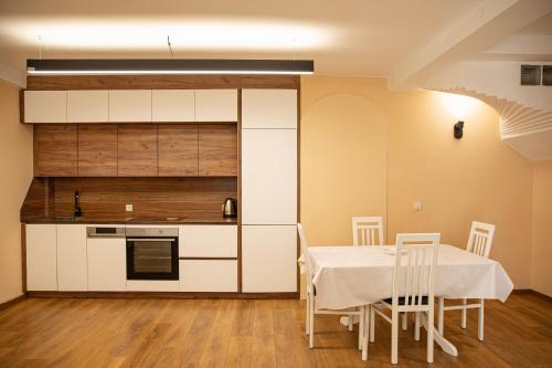 a kitchen and dining room with a table and chairs at Green Oasis in the City Center in Prishtinë