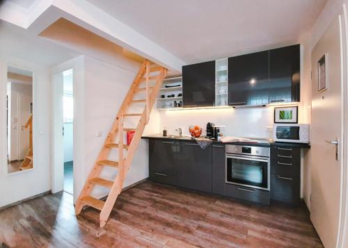 a kitchen with a ladder in the middle of a kitchen at Schubart Apartments in Bietigheim-Bissingen