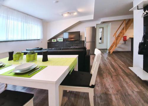 a living room with a table and a couch at Schubart Apartments in Bietigheim-Bissingen