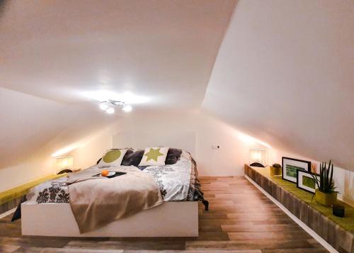 a bedroom with a bed in a white room at Schubart Apartments in Bietigheim-Bissingen