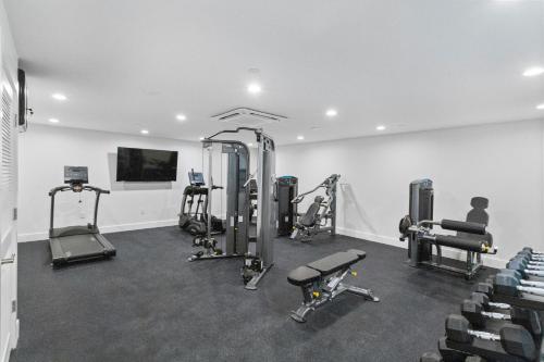 a gym with several treadms and machines in a room at Ocean Club Treasure Island Hotel in St Pete Beach