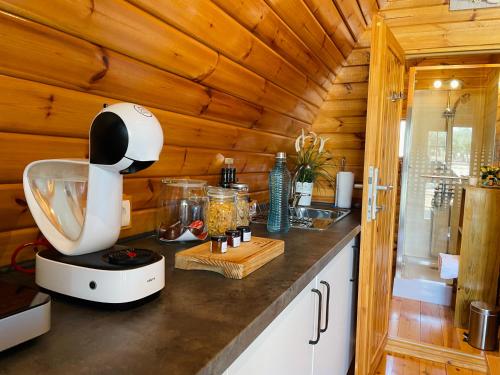 a kitchen with a white blender on a counter at Glamping Turquesa, feel and relax in a wood house in Corredoura