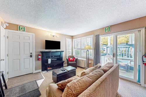 a living room with a couch and a television at Condo 708 at North Creek Resort in Blue Mountains