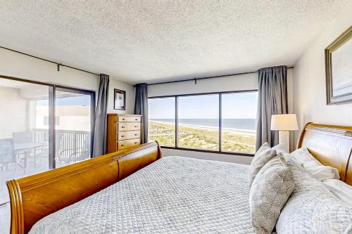 a bedroom with a bed and a view of the ocean at B175 Amelia Surf and Racquet in Fernandina Beach