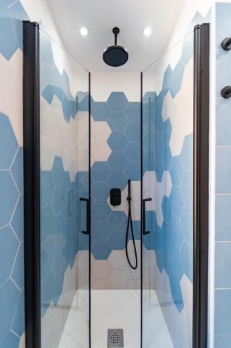 a shower in a bathroom with blue and white tiles at Il Grande Blu in Terracina