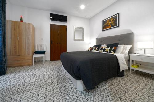 een slaapkamer met een bed met een zwart dekbed bij Casa Ingenio - Exclusive Facility in Ingenio