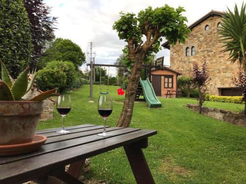 two glasses of wine sitting on a wooden table at Posada Spa San Marcos in Santillana del Mar