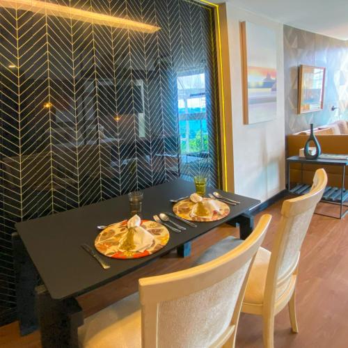 a black table with two plates of food on it at Rio Holiday Boutique Hotel in Niterói