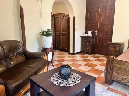 a living room with a couch and a table at Zajazd Cicha Woda in Maniowy
