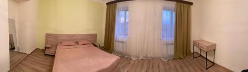 a small room with a bed and a window at Asatryan’s Guest House in Vagharshapat