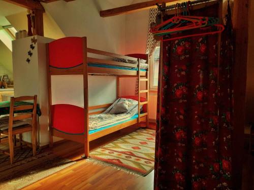 a bedroom with two bunk beds and a table at U WOJTUSIA in Czarny Dunajec