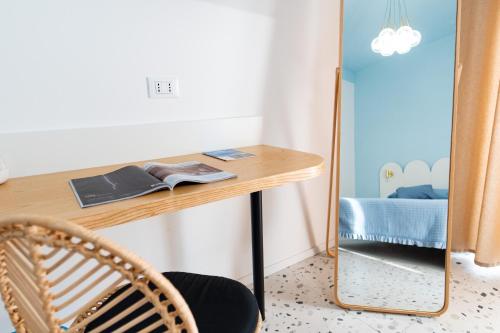 a dressing table with a mirror next to a bed at Il Grande Blu in Terracina