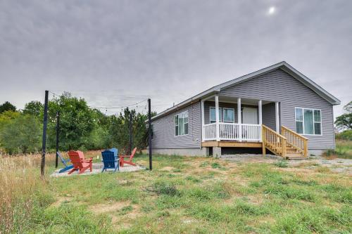 a house with three chairs in front of it at Family Home in Rapid City about 4 Mi to Torch Lake! in Rapid City