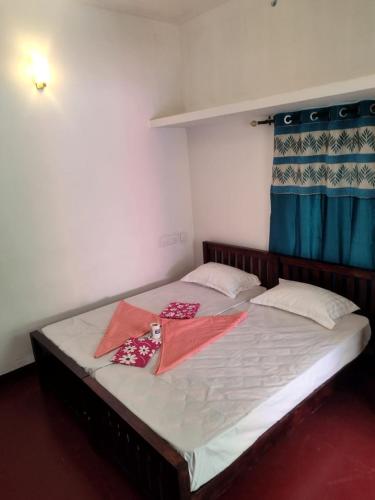 a bed in a room with two pillows on it at Marari diya homestay in Mararikulam