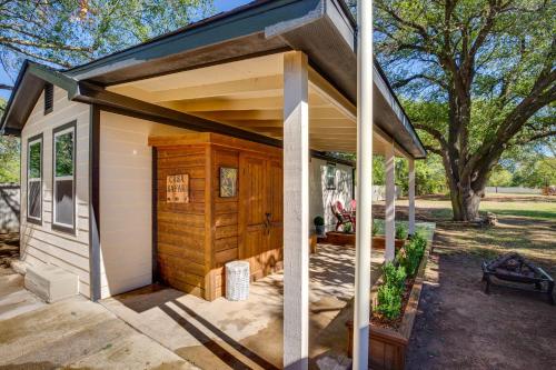 a small white shed with a large door at Couples Retreat In Canton with Patio, Trail and Yard! in Canton