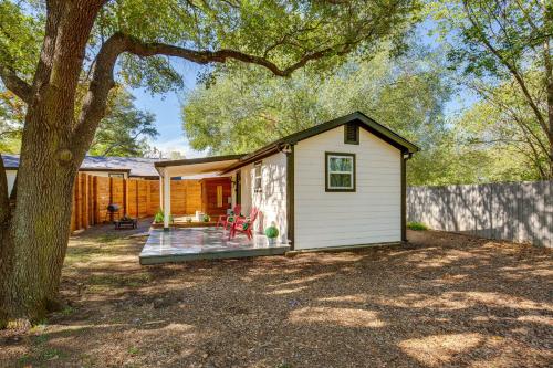 a small white shed with a porch next to a tree at Couples Retreat In Canton with Patio, Trail and Yard! in Canton