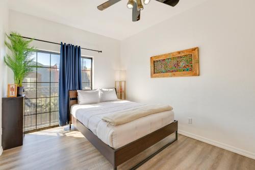 a white bedroom with a bed and a window at Rooftop Patio, Skyline Views Phoenix Townhome! in Phoenix