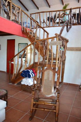 a wooden staircase in a room with a chair at OceanFront Bungalows - Paradise Rentals in Santa Catalina
