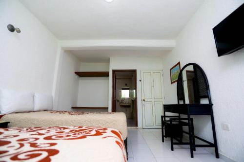 Postel nebo postele na pokoji v ubytování Hotel Maria de Lourdes
