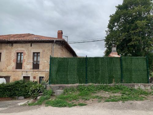 a green fence in front of a house at La Breval in Alles