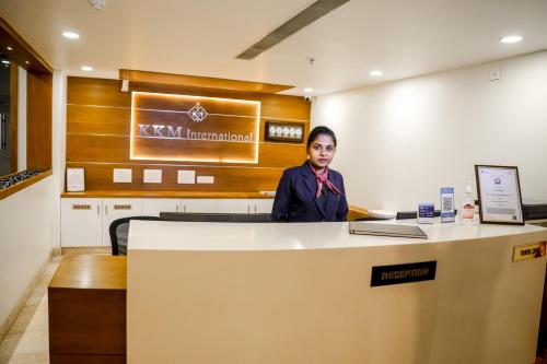 a woman sitting at a counter in an office at KKM INTERNATIONAL in Trivandrum