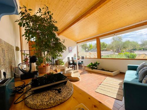 a living room with a blue couch and a table at Tufa Guest House, Wellness & SPA - Villa Campus in Corredoura