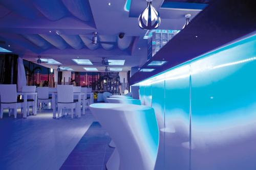 a restaurant with white tables and white chairs at Riu Palace Jamaica - Adults Only - All Inclusive in Montego Bay
