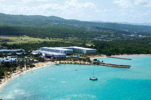 an aerial view of a beach with a boat in the water at Riu Palace Jamaica - Adults Only - All Inclusive in Montego Bay