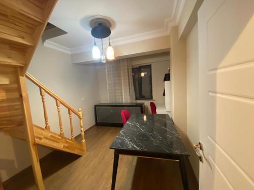 une petite chambre avec une table et un escalier dans l'établissement MUSTAFA KEMALPASA MEH. DEMIRÖZ SK NO: 8/10 ARNAVUTKÖY/ IST, à Arnavutköy