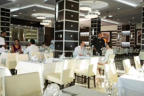 a group of people sitting at tables in a restaurant at Riu Palace Jamaica - Adults Only - All Inclusive in Montego Bay