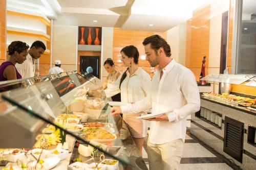 a group of people standing in a buffet at Riu Palace Jamaica - Adults Only - All Inclusive in Montego Bay