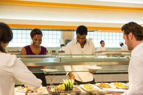 a group of people in a kitchen preparing food at Riu Palace Jamaica - Adults Only - All Inclusive in Montego Bay