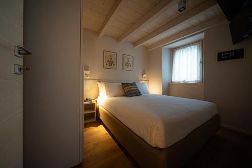 - une petite chambre avec un lit et une fenêtre dans l'établissement Ca Marièt casa vacanze, à Chiavenna