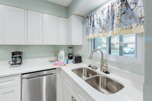 a kitchen with a sink and a window at Beachwalk Condominiums 6F in Panama City Beach