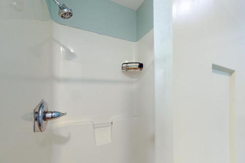 a white bathroom with a shower with a sink at Beachwalk Condominiums 6F in Panama City Beach